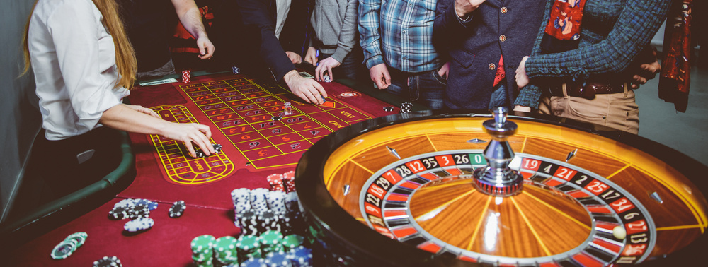 People,play,poker,roulette,at,the,table.,friends,playing,in